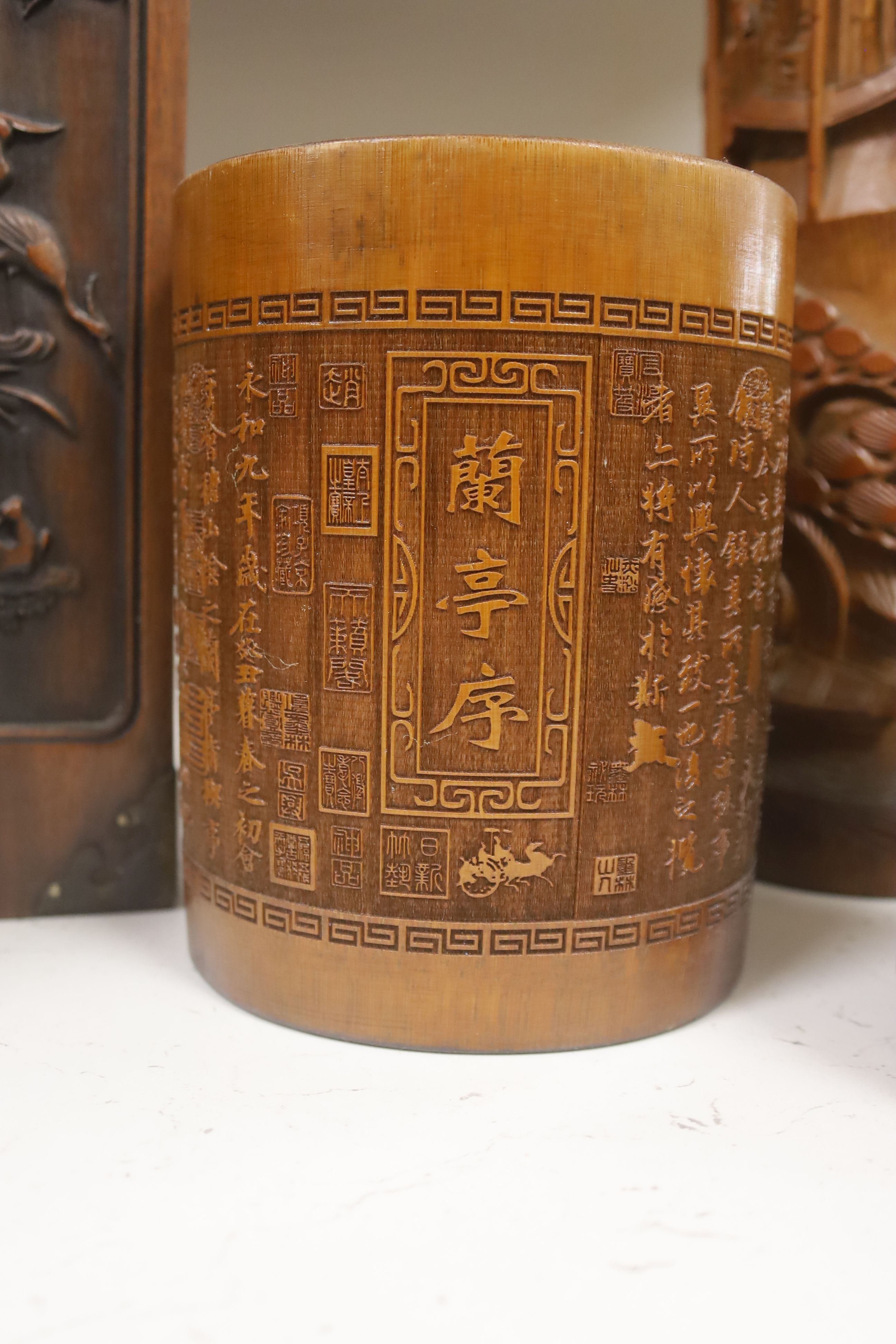 Three Chinese carved bamboo tea caddies and four carved bamboo brush pots